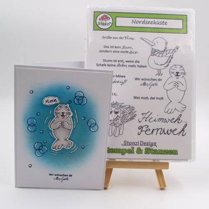 Beispiel-Grußkarte mit Seehundmotiv aus dem Stanzi® Bastelset – Case im Hintergrund sichtbar